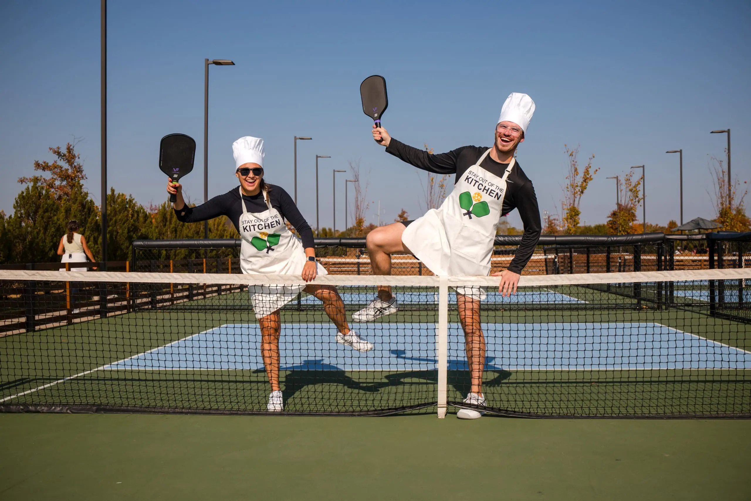 Two pickleball players in matching partner costumes competing at Monster Match Halloween pickleball tournament in Bentonville Arkansas